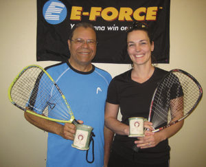 Bob Sanders, left, of Payton, Colo., and Rangely resident Andrea Gianinetti, right, get a “mug shot” taken of the second-place trophies they won in the C/D doubles division of the 23rd Rangely Racquetball Tournament, held March 4-6. One-third of this year’s 29 tournament participants were local, and several of them were mothers brought into the sport by Gianinetti, who began learning from resident expert Shirley Parsons three years ago.