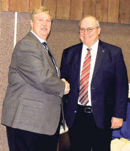 Colorado Northwestern Community College Foundation Board member Sam Tolley, left, thanks and congratulates CNCC President Russell George, right, on his service to the college at the CNCC Foundation’s annual dinner on Saturday. Moments later, George named Tolley the CNCC Person of the Year for all his help.