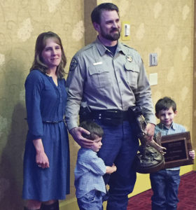 Colorado Parks and Wildlife (CPW) Area Wildlife Manager (AWM) and former Rangely resident Ty Petersburg accepts the John D. Hart Wildlife Officer of the Year Award on Feb. 24 in Colorado Springs. Wife Stephanie Petersburg and sons Lucas, 4, and Boden, 7, joined him in accepting the honor. Petersburg’s parents, Donna and Steve, still live in Rangely.
