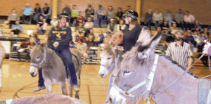 A good crowd was on hand the evening of April 20 as the Meeker Future Farmers of America set up a game of donkey basketball at MHS pitting students against the community (adults). Above, MHS Principal Amy Chinn is caught with the ball as she is surrounded by players on both sides. After four quarters of play, the community team won by the narrowest of margins. They took a big lead in the second quarter and while the students spent the rest of the game nearly closing the gap, time ran out on their hopes to beat, as one student put it, “the old folks.”