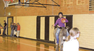 Trina Smith played on the community team on April 20 during the Meeker Future Farmers of America fundraising Donkey Basketball game in the MHS auditorium. The contest pitted MHS students against the community (adults). The community (old folks) jumped to a big lead in the second quarter, and while the students tried to mount an attack during the second half, they came up short by two points.