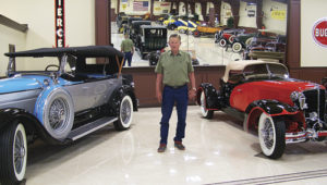 Bud Striegel of Rangely, owner of the Rangely Automotive Museum, stands with some of the cars he initially moved into the museum in 2015. With the museum having started in 2014, Striegel has finally announced that he will publicly open the doors on Saturday.