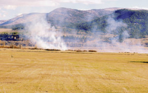 As we get farther into spring, the skies from a distance may appear as though Rio Blanco County is awash with fire and smoke. The reality is a lot of the county’s farm and ranch land is being burned on purpose to eliminate wild grasses that could lead to large-scale fires. Above, this controlled burn is taking place south of Highway 64 about eight miles west of Meeker.