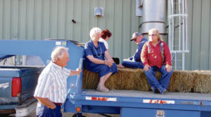 Friday evening was a great time to be outdoors during the White River and Douglas Creek conservation districts’ landowner appreciation dinner at the Upper Colorado Environmental Plant Center on County Road 4. Plant Manager Steve Parr, left, directs the loading of the hay wagon for the plant center tour. Elinor Williams, Julie Pearce, Hal Pearce and Julie Jansen await others to load and join them on the hay bales.