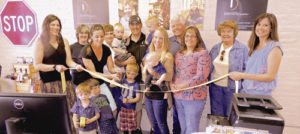 The Meeker Chamber of Commerce held a ribbon cutting Thursday evening for the grand opening of Identity Graphics, located at 640 Main St. in Meeker. The company, which specializes in specialty printing of signs, banners and decals as well as specialty graphic design, is open Monday through Friday from 10 a.m. to 4 p.m. The phone number is 970-878-3103. Present for the ribbon cutting, from left to right, were: chamber board President Diana Jones, Dawn Jastrom (chamber), Carly Thomson (Identity Graphics), JoAnn Goss-Gardner (chamber), Hyram Seely, owner Dan Seely, David Seely, owner Ashleigh Seely holding Johnathan Seely, Dan Seely, Cheryl Browning, Eva Jean Seely and chamber Executive Director Stephanie Kobald. In the front row, from left, are Quinn Thomson, Ollie Thomson and Liam Thomson. Dan and Ashleigh Seely also own Identity Graphics in Craig as well as a number of other businesses. 