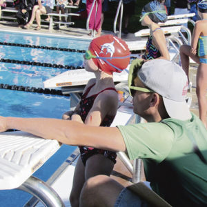 Meeker Marlin swimmer Brooklynn Nielsen gets some instruction from coach Chance Walker immediately before winning the 25-yard backstroke at the High Country Swim League Championship Meet in Eagle on July 29.  